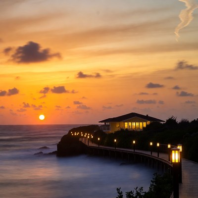 Sunset over beach house on wooden pier