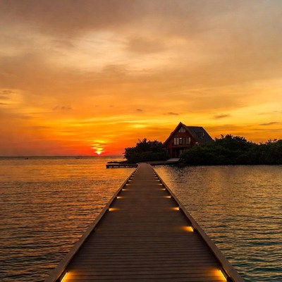 Red House on Pier at Sunset