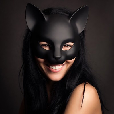 Woman smiling in black cat mask