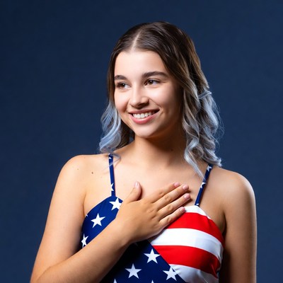 Girl pledging allegiance in American flag swimsuit