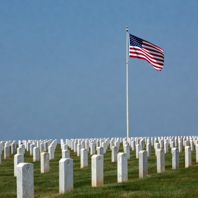 American Flag over White Tombstones