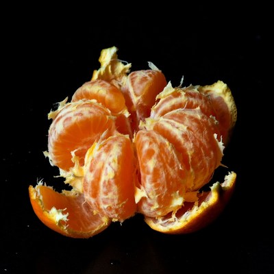 Peeled Mandarin Orange on Black Background