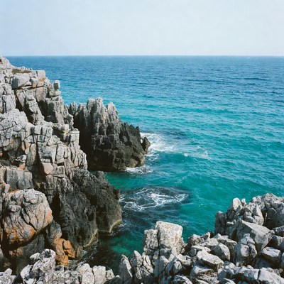 Rocky Cliffs Over Turquoise Ocean
