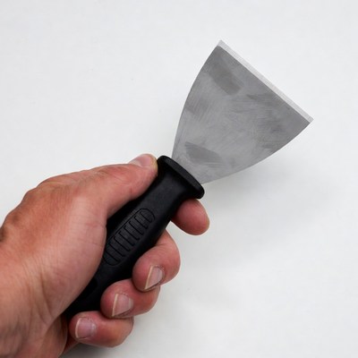 Man holding putty knife