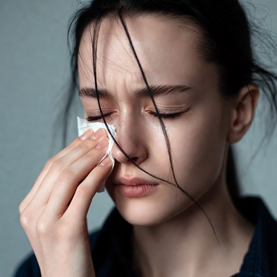 Woman crying with tissue