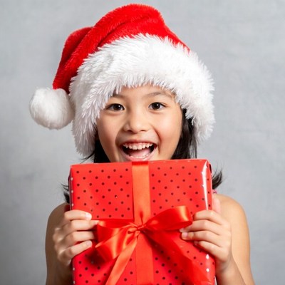 Asian girl holding Christmas gift