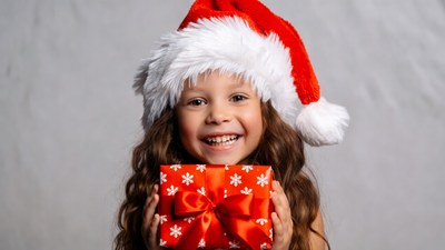 Girl holding red Christmas gift