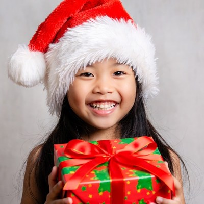 Asian girl holding Christmas present