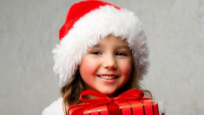 Girl holding red Christmas gift
