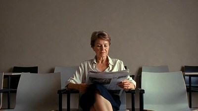 Mature woman reading newspaper