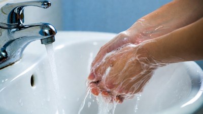 Hands washing under faucet