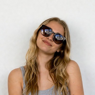 Blonde woman smiling in sunglasses