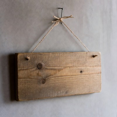 Blank wooden sign hanging on wall