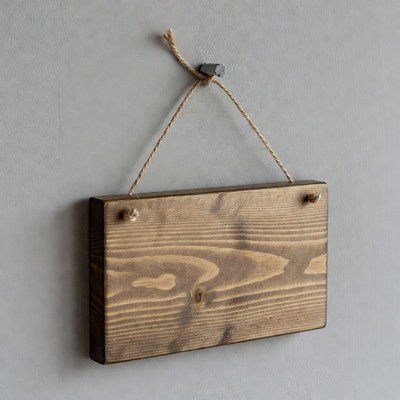 Blank wooden sign hanging on wall