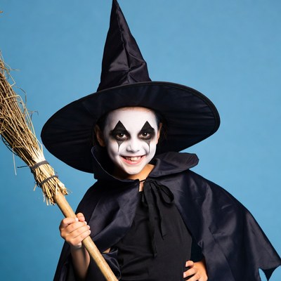 Girl in witch costume with broom