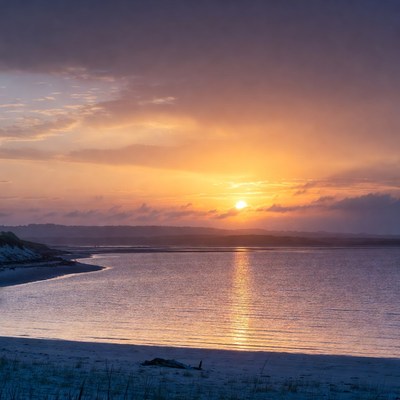Sunset over beach and calm water