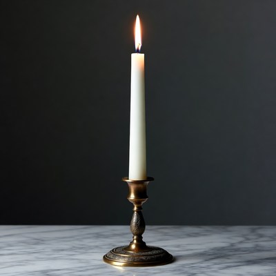 Lit White Candle in Brass Holder