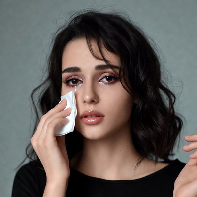 Woman crying holding tissue
