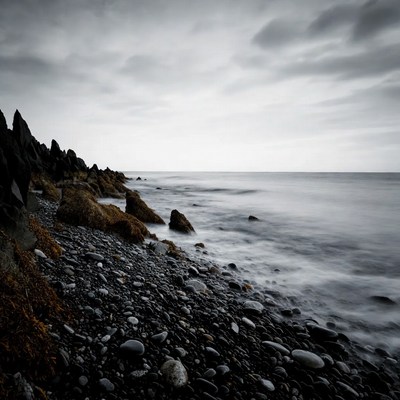 Black Pebbles and Long Exposure Ocean Waves