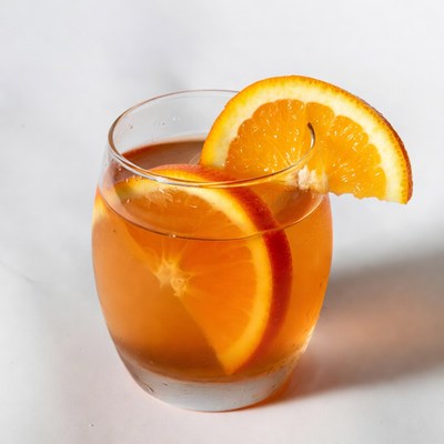 Orange slice garnish on cocktail glass