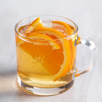 Glass of hot water with orange slices