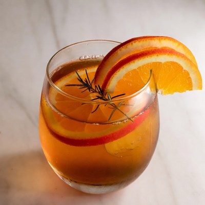 Cocktail with orange slices and rosemary