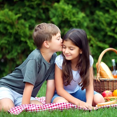 Boy kissing girl on picnic