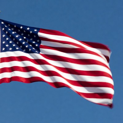 American Flag Waving in Blue Sky