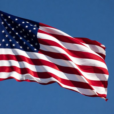 American flag waving against blue sky