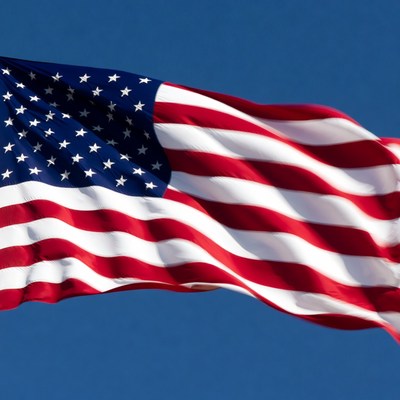 American flag waving against blue sky