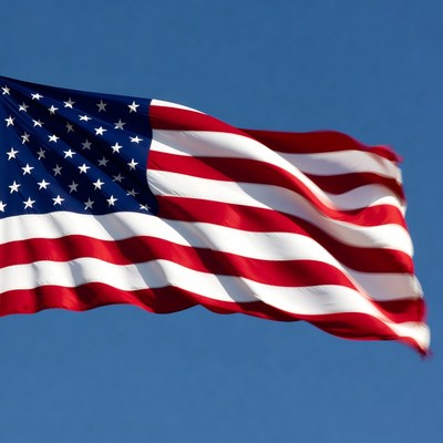 American Flag Waving in Blue Sky