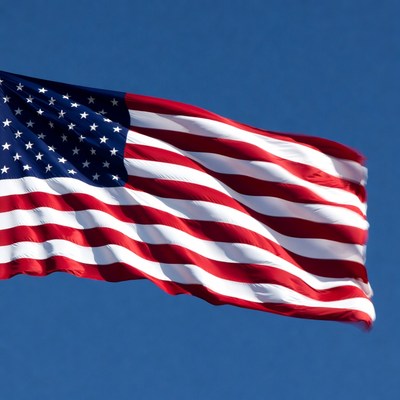 American flag waving against blue sky