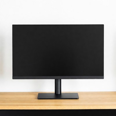 Black monitor on wooden desk