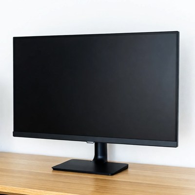 Black monitor on wooden desk