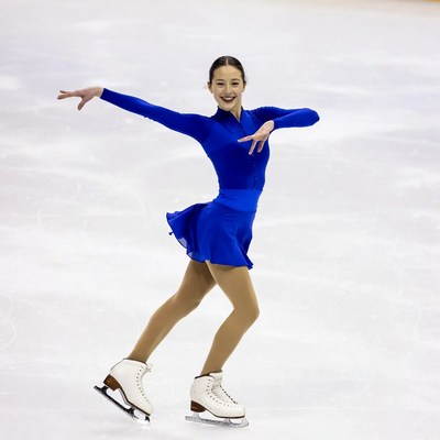 Asian girl figure skating on ice