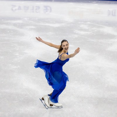 Girl figure skating in blue dress