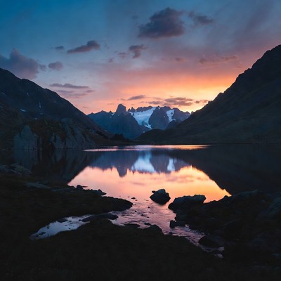 Sunset over mountain lake reflection