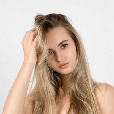 Blonde woman touching hair