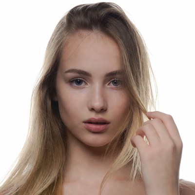 Blonde woman touching hair