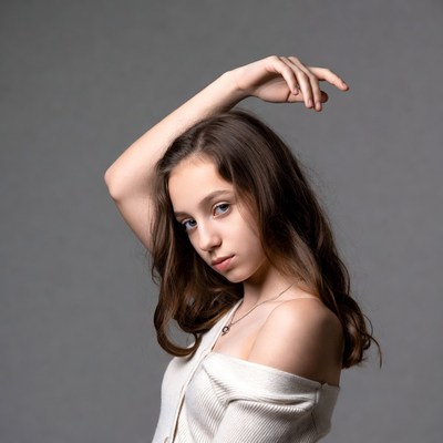 Teen girl posing with hand on head