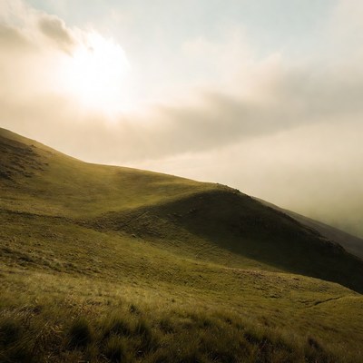 Green Hills with Sunlight and Clouds