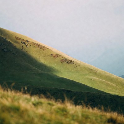 Green hillside with shadows