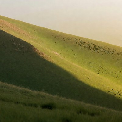 Green hillside with shadows