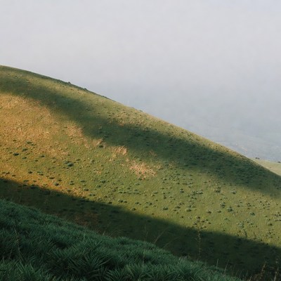 Green Hill with Shadows in Fog