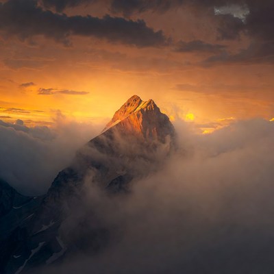 Mountain Peak at Sunset with Clouds