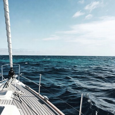 Sailboat on turquoise ocean waves