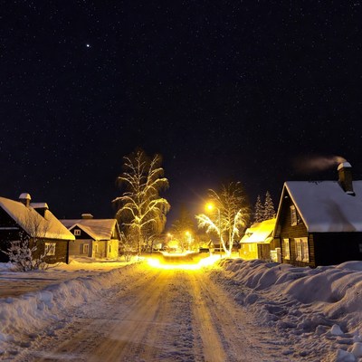 Snowy Village Street at Night