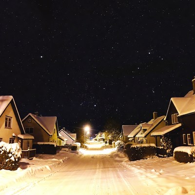 Snowy Street with Houses Under Starry Night
