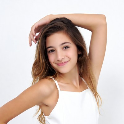 Smiling girl posing with hand on head