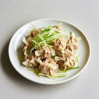 Dumplings with green onions on plate